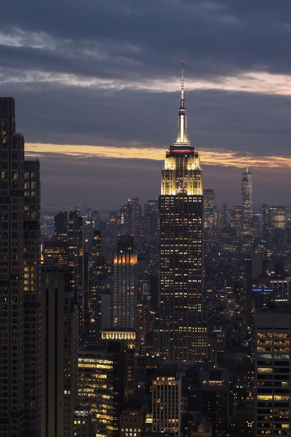 A city skyline at dusk with lit towers