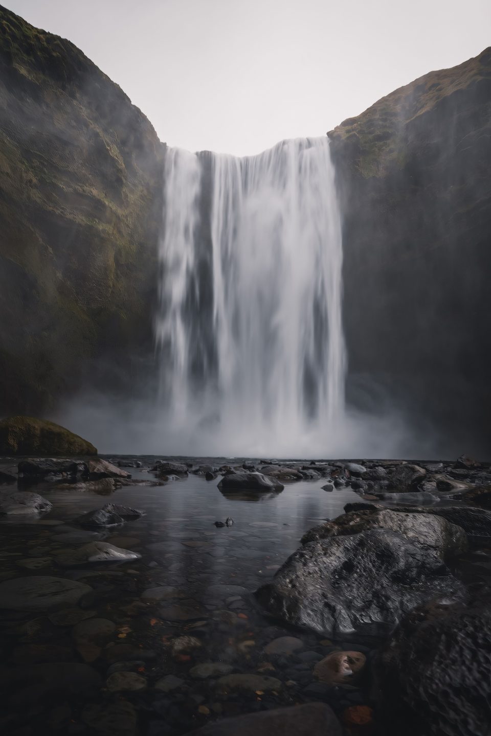 A waterfall pouring into a rocky pool